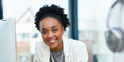 A young businesswoman smiling at her workplace - Self-Mastery: A Plan for Personal Success