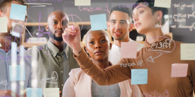 Happy businessman writing a business plan on a whiteboard to his team on a meeting in the board room - Agile Scrum - Emotional Intelligence (EQ) for Leaders