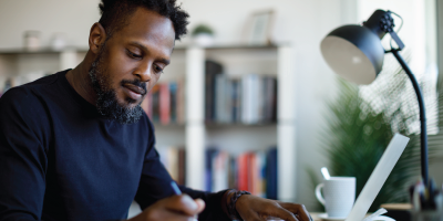 Man working at home - resume writing - Effective Performance Reviews
