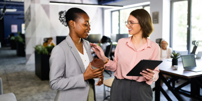 Workplace Civility Training Course 37 Two female government professionals collaborating in a modern office setting.